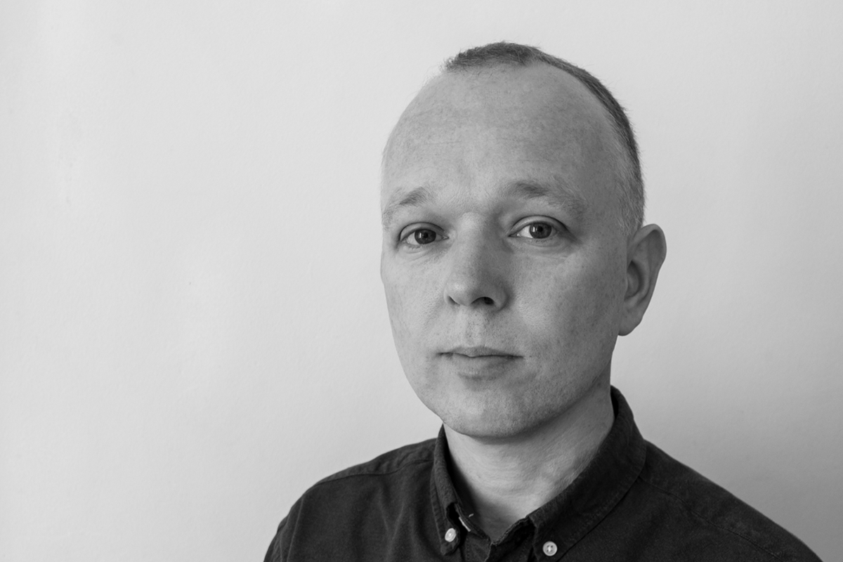 Black and white profile image of graphic design professional Brett Weekes.